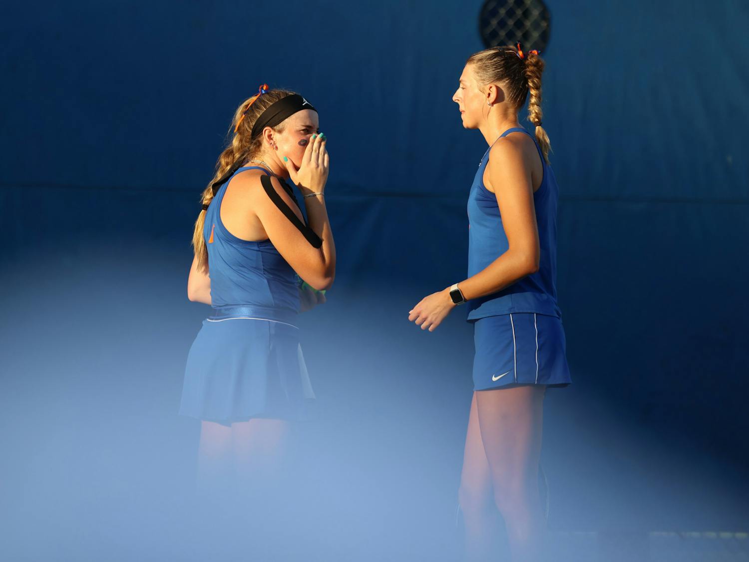 Florida senior Carly Briggs and sophomore Alicia Dudeney talk to each during their doubles match in the Gators' matchup against the Pepperdine Waves Friday, Feb 24, 2023.