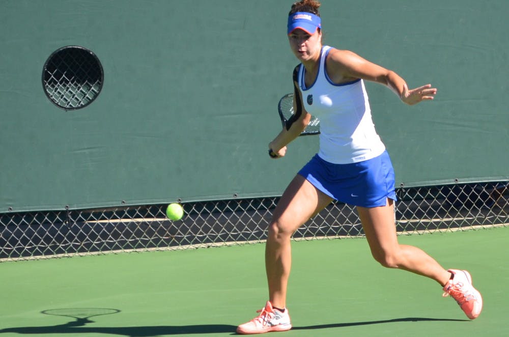 Freshman Stefani Stojic swings at the ball during her  first round singles match against USF freshman Olaya Garrido-Riyas on Oct. 10 during the Bedford Cup at the Ring Tennis Complex.