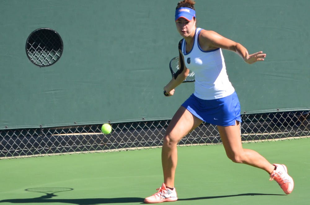 <p>Freshman Stefani Stojic swings at the ball during her  first round singles match against USF freshman Olaya Garrido-Riyas on Oct. 10 during the Bedford Cup at the Ring Tennis Complex.</p>