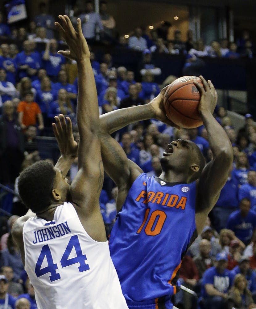 Florida forward Dorian Finney-Smith (10) shoots against Kentucky center Dakari Johnson (44) during the second half of an NCAA college basketball game in the quarter final round of the Southeastern Conference tournament, Friday, March 13, 2015, in Nashville, Tenn.
