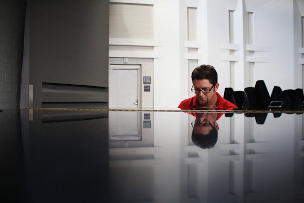 <p>UF jazz professor Scott Wilson poses as he plays the piano inside the Steinbrenner Band Building Sunday afternoon. Wilson released an Earth, Wind and Fire tribute album on Grooveshark.</p>