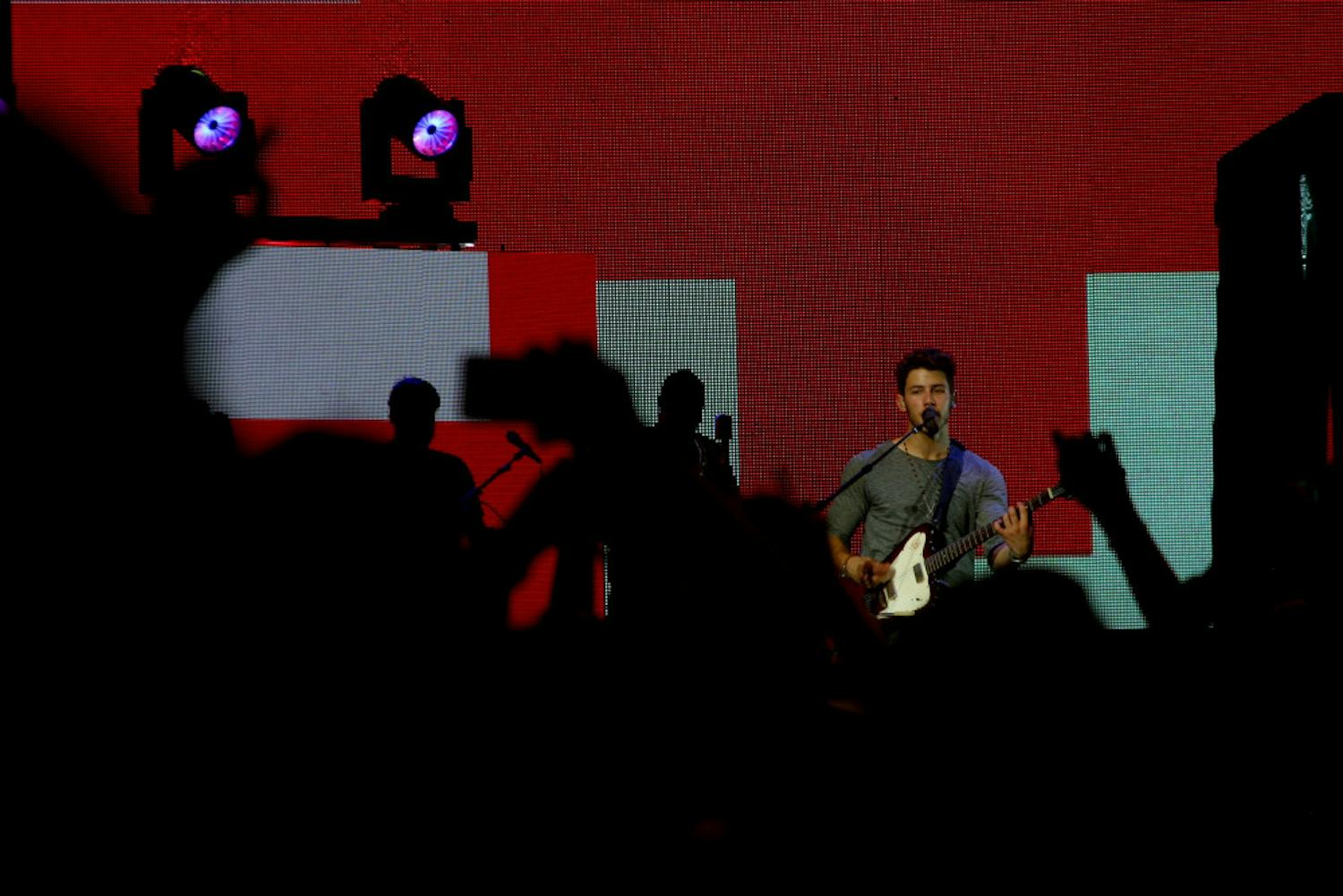Nick Jonas serenades the cheering crowd at the Jonas Brothers’ concert last week in West Palm Beach. The band recently released new music for the first time in years. 