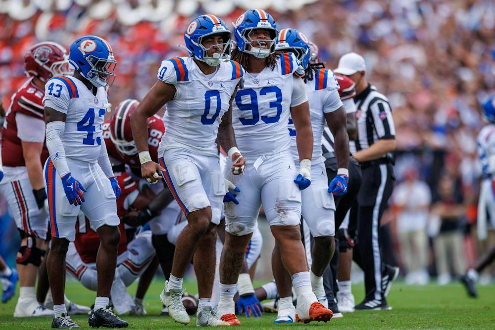 Florida linebacker Jayden Woods (0) and defensive lineman DK Kalu (93) celebrate during the first half of an NCAA college football game against South Carolina, Saturday, Oct. 10, 2026, in Gainesville, Fla.