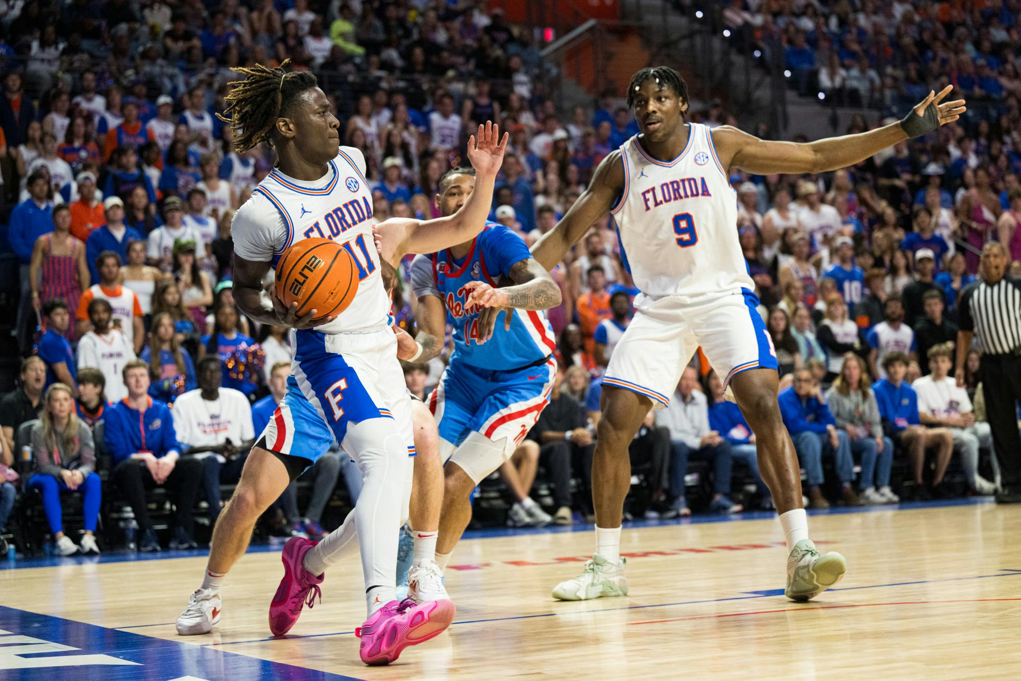 Florida Gators guard Denzel Aberdeen (11) passes the ball as he falls out of bounds in a basketball game against Ole Miss on Saturday, March 8, 2025, in Gainesville, Fla.