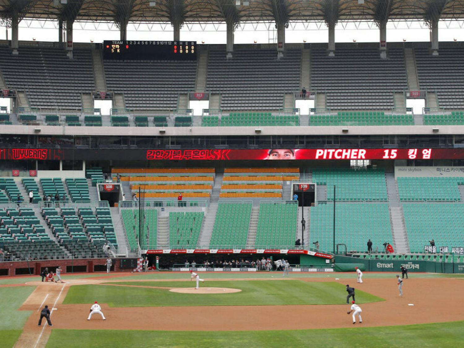 Stadium seats are empty as a part of precaution against the new coronavirus during a baseball game between Hanwha Eagles and SK Wyverns in Incheon, South Korea, Tuesday, May 5, 2020. With umpires fitted with masks and cheerleaders dancing beneath vast rows of empty seats, a new baseball season got underway in South Korea following a weeks-long delay because of the coronavirus pandemic. (AP Photo/Lee Jin-man)