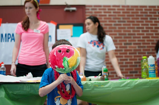 Maximus Pulefko holds up his painting during Stomp the Swamp for Autism on Saturday.
