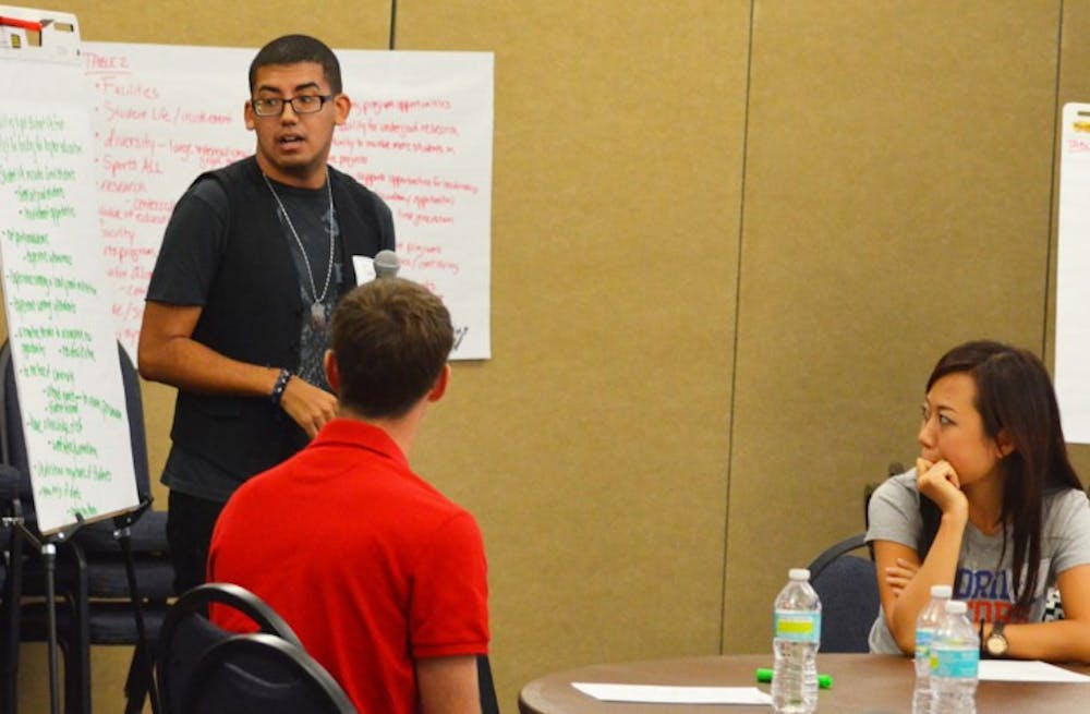 <p>Juan Rodriguez, Student Senate treasurer, discusses UF’s strengths and qualities with other students during a forum on the presidential search</p>