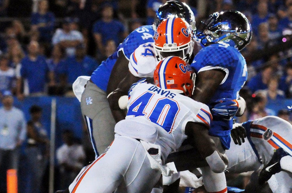 <p>UF linebacker Jarrad Davis (40) and defensive lineman Bryan Cox Jr. record a tackle during Florida's 14-9 win against Kentucky on Sept. 19, 2015, at Commonwealth Stadium in Lexington, Kentucky.</p>