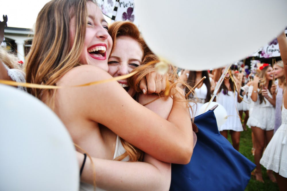 Jacquelyn Siegel (right), an 18-year-old UF exploratory freshman, embraces Caitlyn Hall, a 19-year-old UF event management sophomore (left), while she joins Zeta Tau Alpha on Wednesday afternoon during Bid Day Fall 2016.