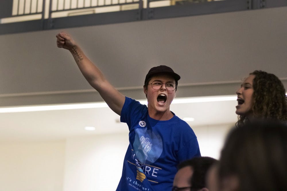 Ryan Wilder, a member of Inspire Party, cheers after the results of the election were announced Wednesday night. Inspire won the majority of the Senate seats for the first time in the party’s history. 