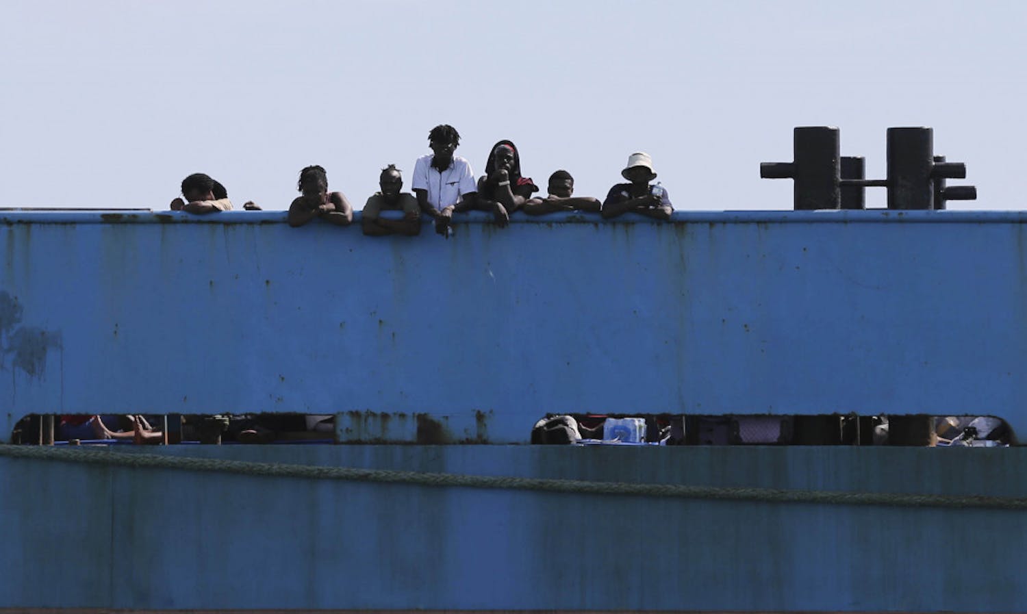 People look out from a ferry as they wait to be evacuated to Nassau in the aftermath of Hurricane Dorian, from the port of Marsh Harbor, Abaco Island, Bahamas, Sunday, Sept. 8, 2019. It's been nearly a week after Dorian roared in from the sea as the most powerful hurricane in the northwestern Bahamas' recorded history.(AP Photo/Fernando Llano)