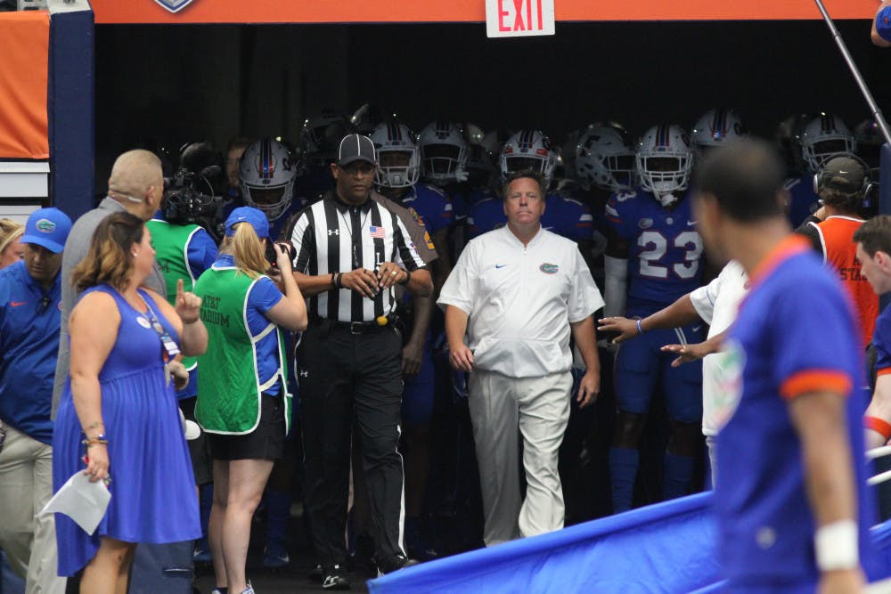 Led by coach Jim McElwain, the Gators take the field against Michigan on Sept. 2 in Arlington, Texas. 