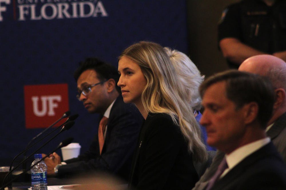 Lauren Lemasters, UF student body president, listens to public comment at the Board of Trustees meeting discussing Ben Sasse’s candidacy on Tuesday, Nov. 1, 2022.