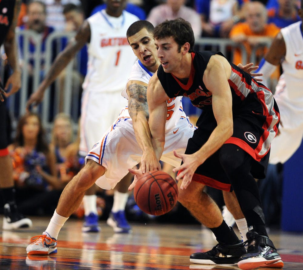 <p>Florida's Scottie Wilbekin (5) tries to break the ball lose from
Georgia's Connor Nolte (20) during the first half of an NCAA
college basketball game in Gainesville, Fla., Tuesday, Jan. 10,
2012.</p>