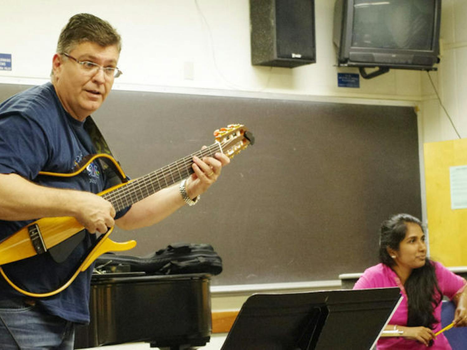 Welson Tremura, associate professor of music and director of the Brazilian Music Institute, teaches Brazilian techniques in the music building Wednesday morning.&nbsp;
&nbsp;
