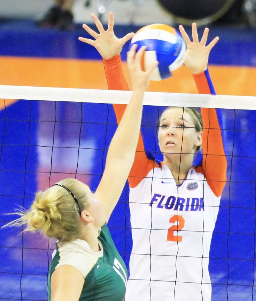 Dana Backlund prevents the ball from going over the net during Florida's win over Jacksonville Friday night at Stephen C. O'Connell Center.