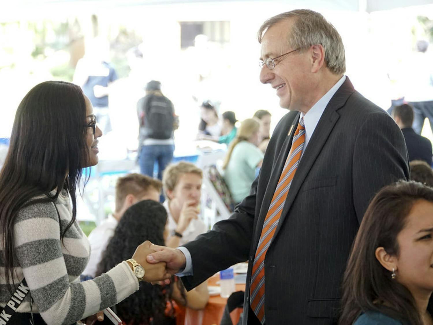 Daniela Gonzalez, an 18-year-old UF accounting freshman, shakes hands with President Fuchs during the Inauguration Week student event on the Reitz North Lawn on Nov. 30, 2015. Gonzalez, an assistant student government treasurer, said she has met Fuchs before but was happy to see him again.