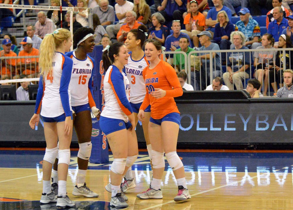 <p>UF players celebrate during Florida's 3-0 win against Alabama State in the first round of the NCAA Tournament in the O'Connell Center.</p>