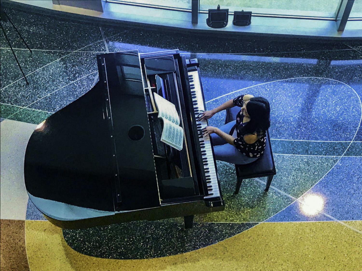 UF’s International Piano Festival participant Ahui plays classical music at UF Health Shands Hospital.