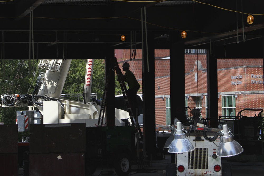 <p>A lone construction worker climbs a ladder on Sept. 30, 2015, inside what will become the Otis Hawkins Center for Academic and Personal Excellence, an extension to Farrior Hall, the main academic advising building on UF's campus. Construction on the building is due to be completed December 2016.</p>