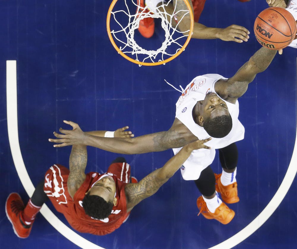Florida forward Dorian Finney-Smith (10) shoots over Alabama guard Justin Coleman (5) during the second half of an NCAA college basketball game in the second round of the Southeastern Conference tournament, Thursday, March 12, 2015, in Nashville, Tenn. Florida won 69-61.