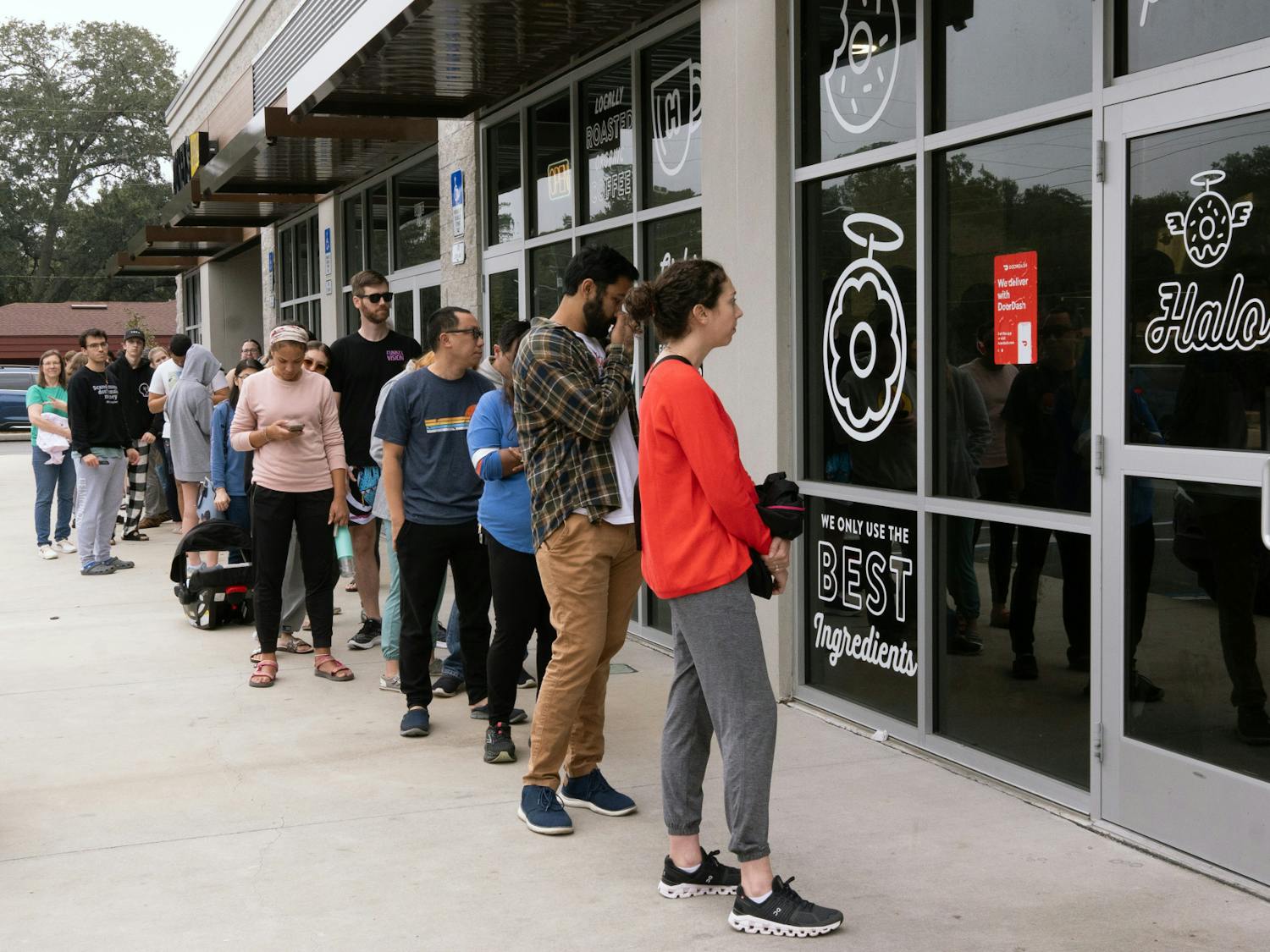 Halo customers wait in a line outside the store on Tower Road to get the last potato donuts on Saturday, Dec. 2, 2023.