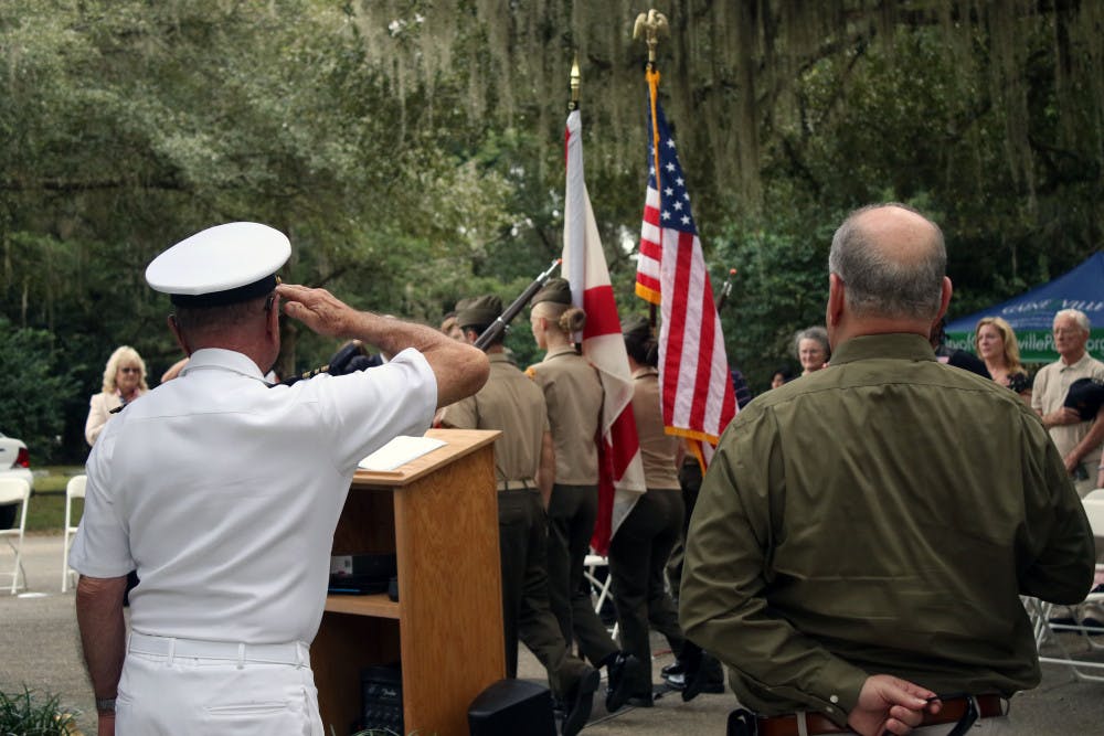 <p><span>Retired Lt. Commander Gary Cook (L) salutes the flag as the Milton Lewis Young Marines present the colors at a Veterans Day event at Evergreen Cemetery in Gainesville on Monday, Nov. 12, 2018. The event was held to honor the veterans buried in the cemetery and to commemorate the 100th anniversary of the end of World War One.</span></p>