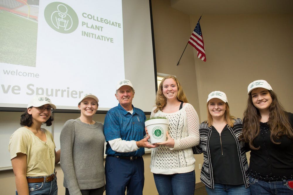 Winner of the Florida memorabilia, Jessica Finkel, poses with former UF coach Steve Spurrier after being chosen to receive a piece of turf from The Swamp.