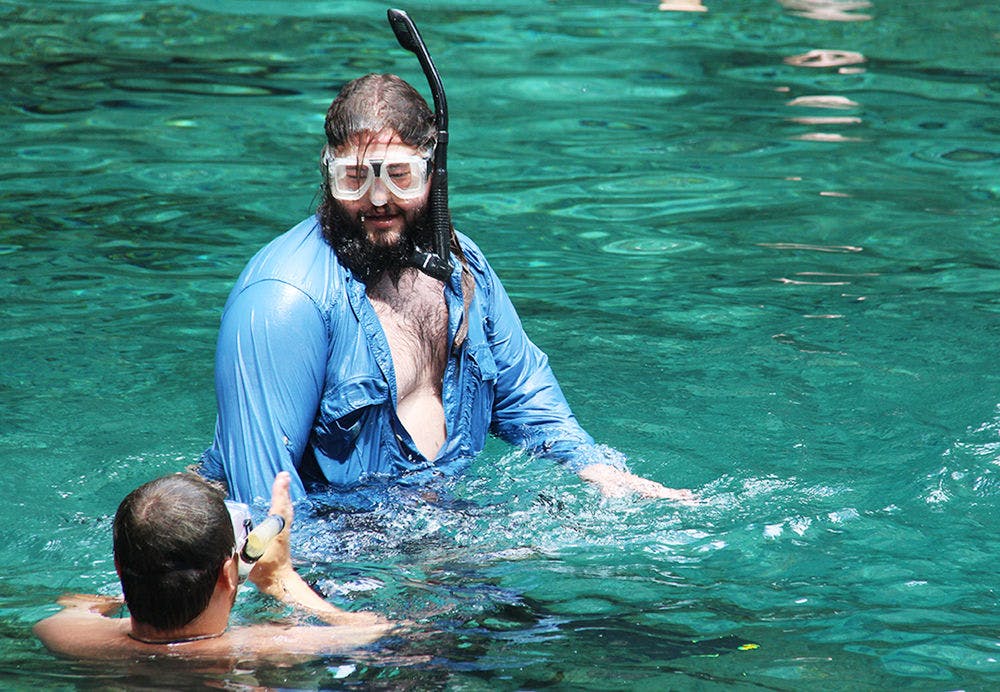 <p>Nathan Gublis, 23, talks to his friend Wes Hay, 23, at Ginnie Springs Monday. The two drove with a group of friends from St. Petersburg to celebrate the long weekend.</p>