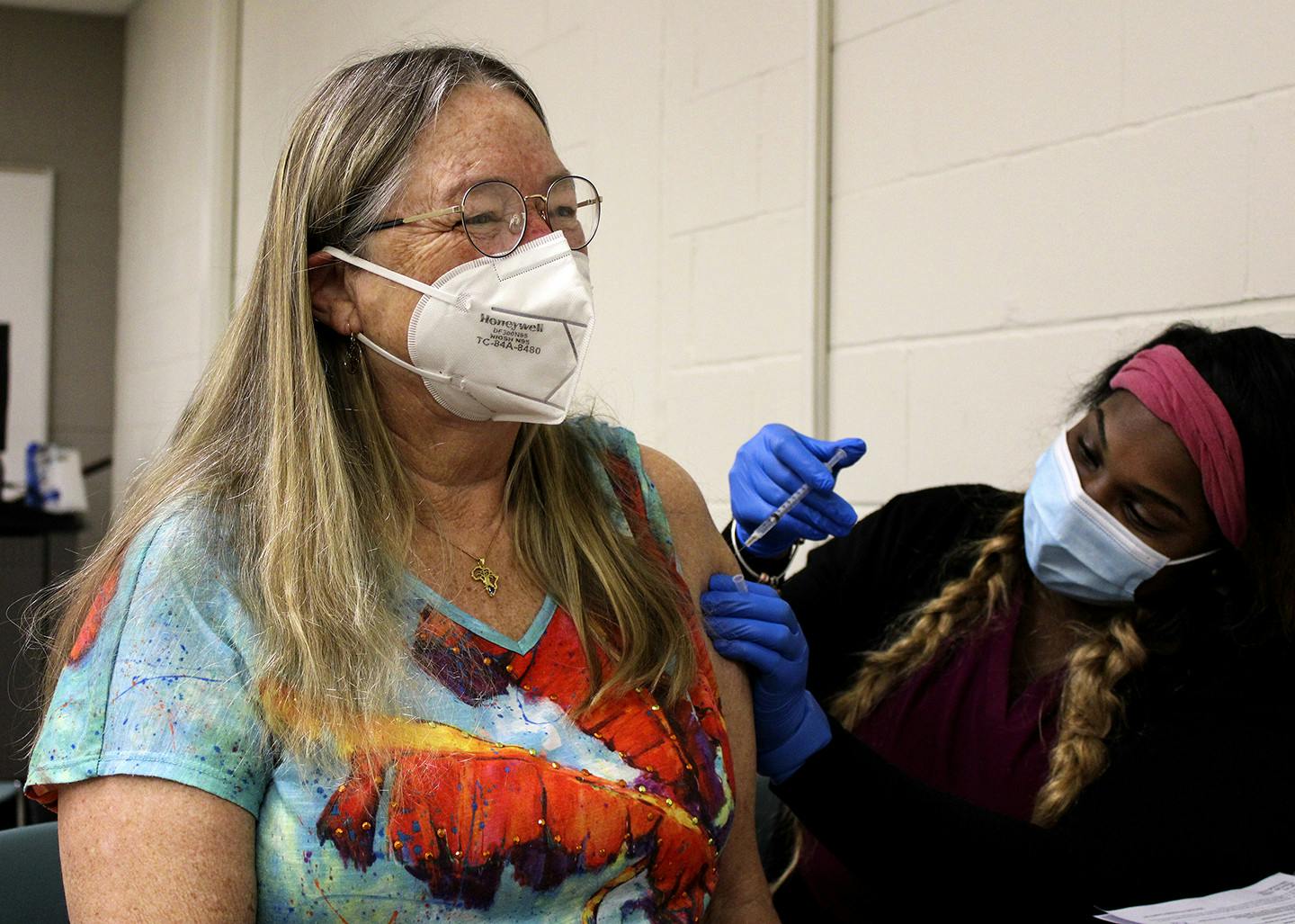 Janée Gilliam, a nurse for the Alachua County Department of Health, injects Linda Tyson, 65, a Sante Fe biology professor, with the Pfizer-BioNTech COVID-19 vaccine Friday, Feb. 26, 2021 at Santa Fe College. “The college has done us a great service,” Tyson said about the vaccine distributions.