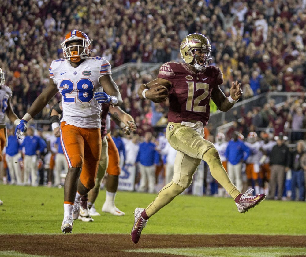 <p>Florida State quarterback Deondre Francois reacts to scoring a touchdown in front of Florida linebacker Kylan Johnson during the second half of an NCAA college football game in Tallahassee, Fla., Saturday, Nov. 26, 2016. Florida State defeated Florida 33-13. (AP Photo/Mark Wallheiser)</p>