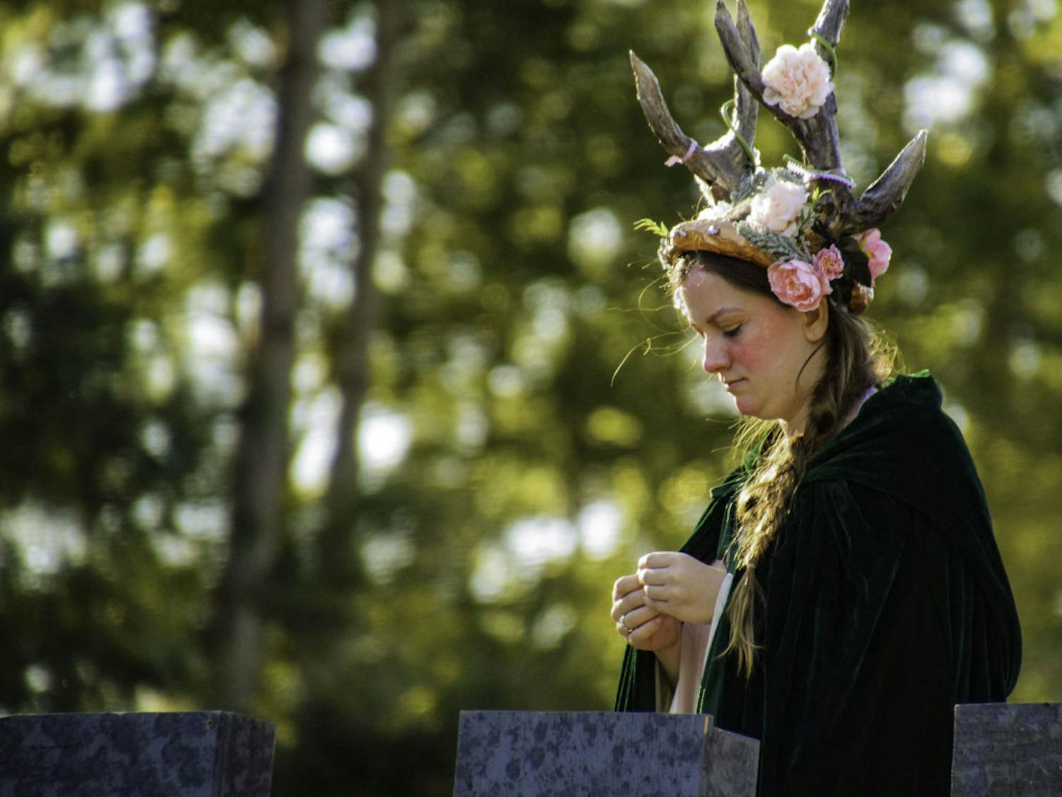 Thieves Guilde actor Ellie Smith, 18, looks down at the chessboard from a prop castle.