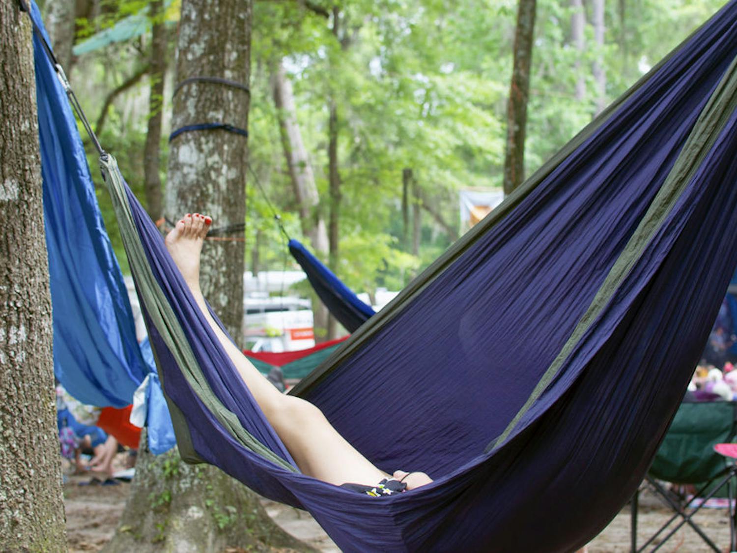A Wanee Music Festival attendee relaxes in a hammock on Saturday. Located on the Spirit of the Suwannee Music Park in Live Oak, Florida, the music festival allowed guests to camp during the three days of the event.