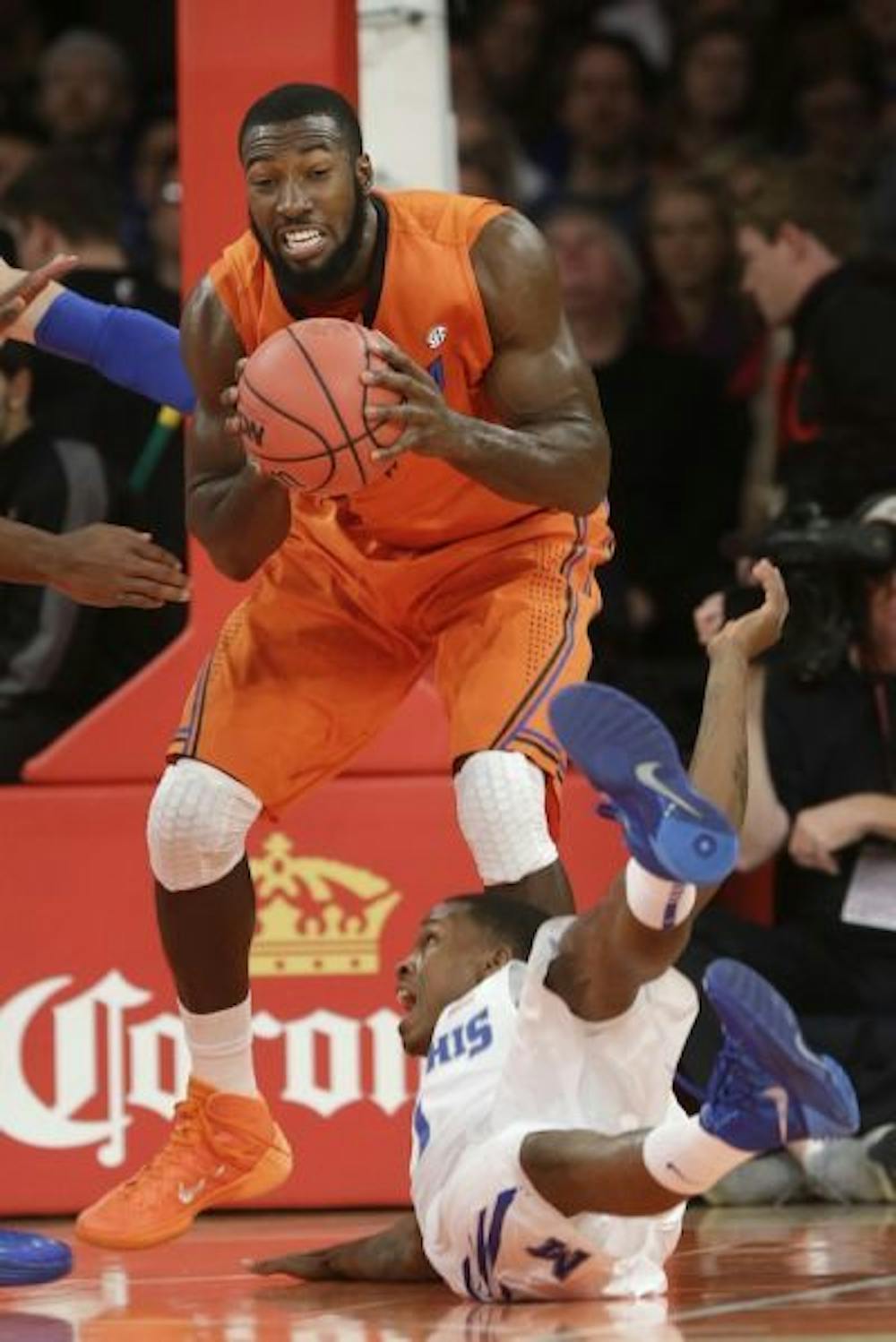 <p>Senior Patric Young comes down with a rebound over Memphis' Joe Jackson in Florida's 77-75 victory on Dec. 17. The Gators center finished with eight points and eight rebounds.</p>