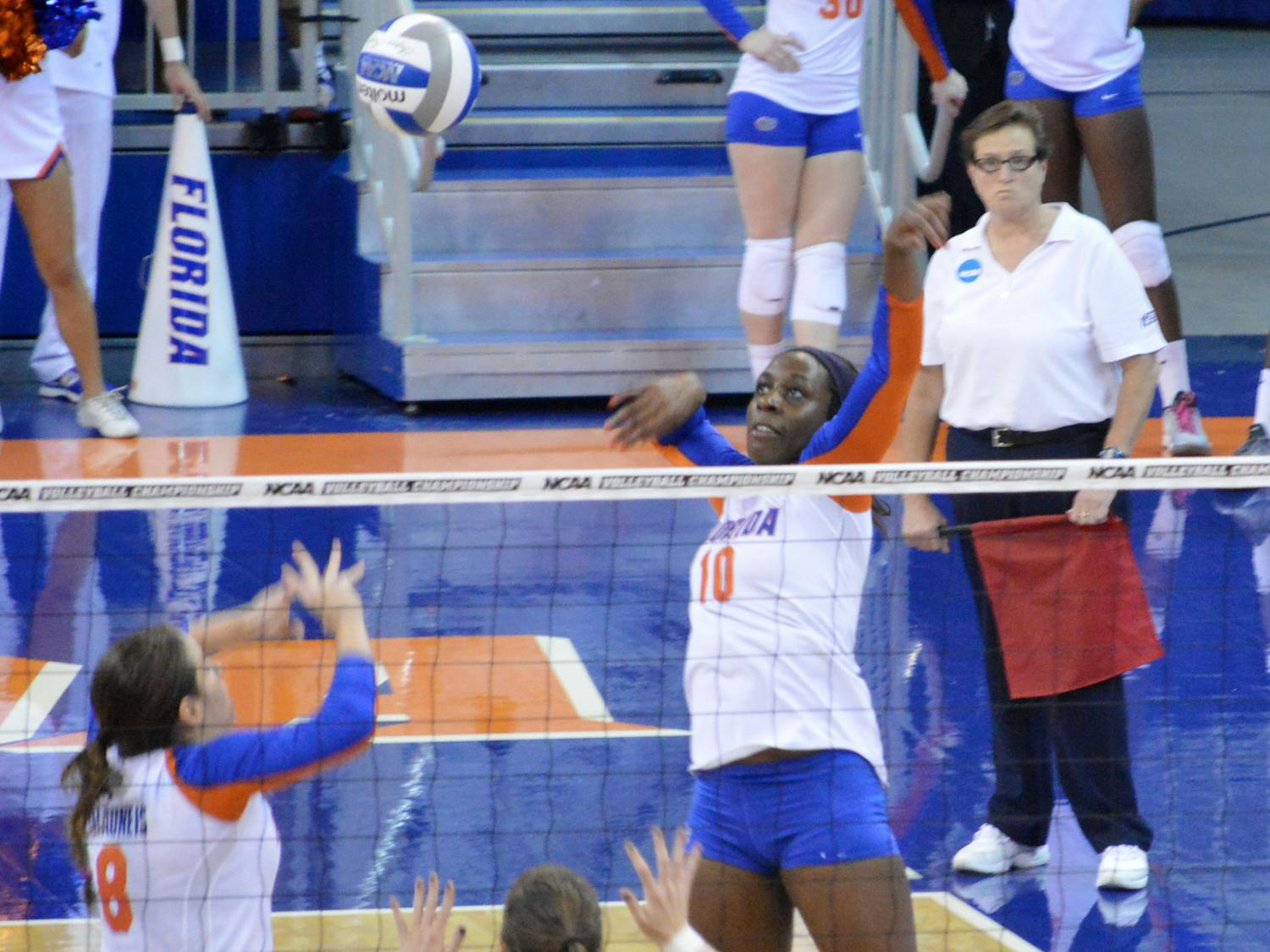 Redshirt senior middle blocker Chloe Mann swings at the ball set to her by senior setter Taylor Brauneis during Florida’s 3-0 victory against Jacksonville on Thursday in the O’Connell Center. Mann had a team-high 15 kills against the Dolphins.