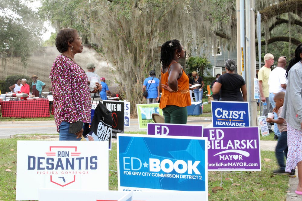 <p>Voters listen to local candidates ﻿speak at the Souls to the Polls event held outside of the Alachua County Supervisor of Elections Office Sunday, Nov. 6, 2022.</p>