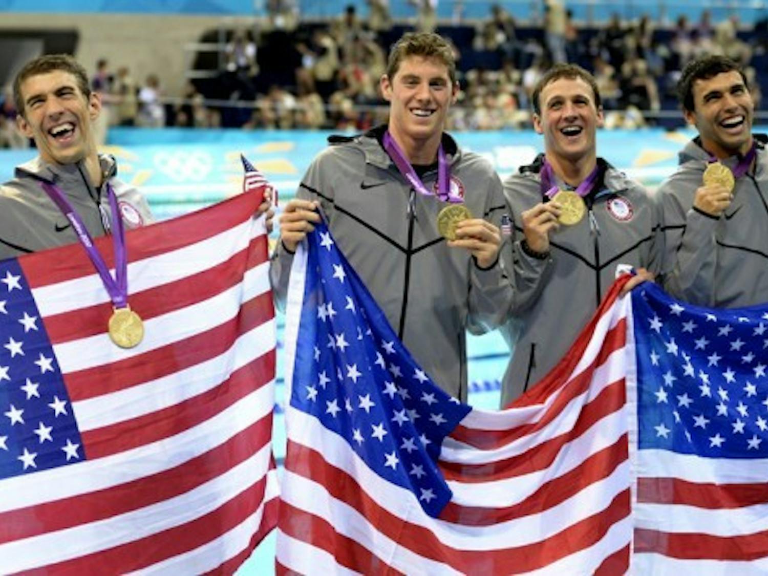 The U.S. men’s 4x200m freestyle relay team poses with its gold medals after the race Tuesday in London. Former Gators Conor Dwyer (middle left) and Ryan Lochte (middle right) helped Michael Phelps (far left) earn his 15th gold medal and record-breaking 19th Olympic medal.