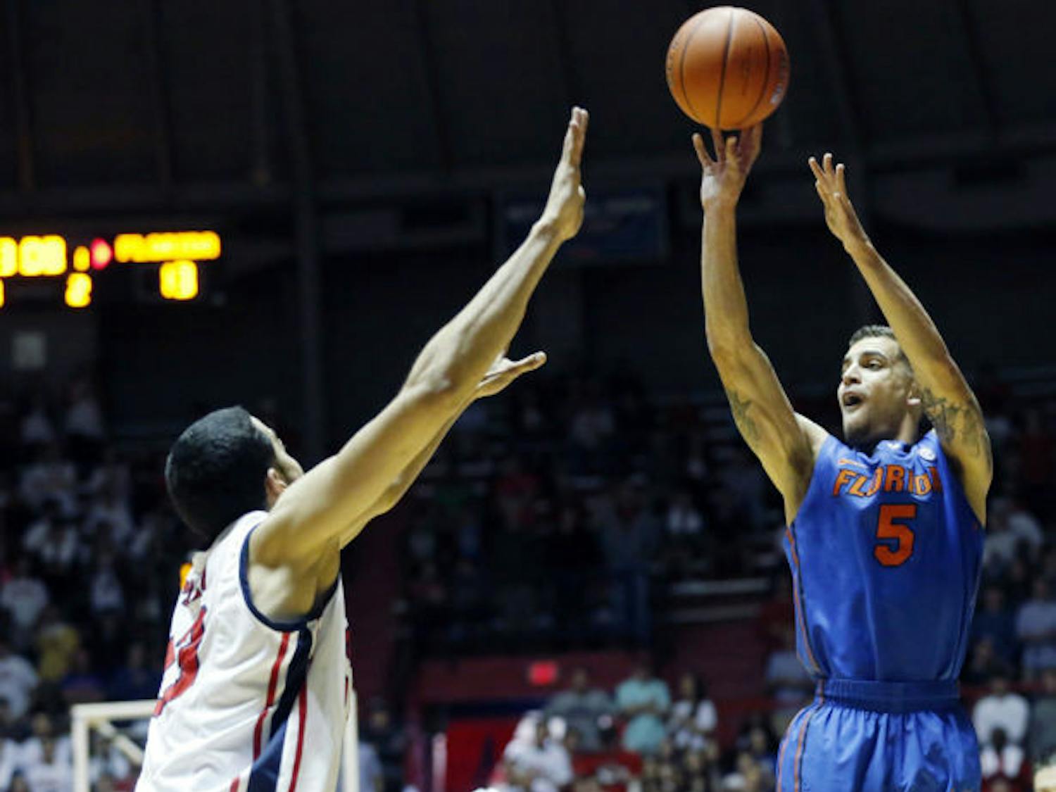 Scottie Wilbekin (5) attempts a shot as Ole Miss forward Anthony Perez (13) tries to block during Florida’s 75-71 win in Oxford, Miss., on Saturday. Wilbekin scored a team-high 18 points against the Rebels.