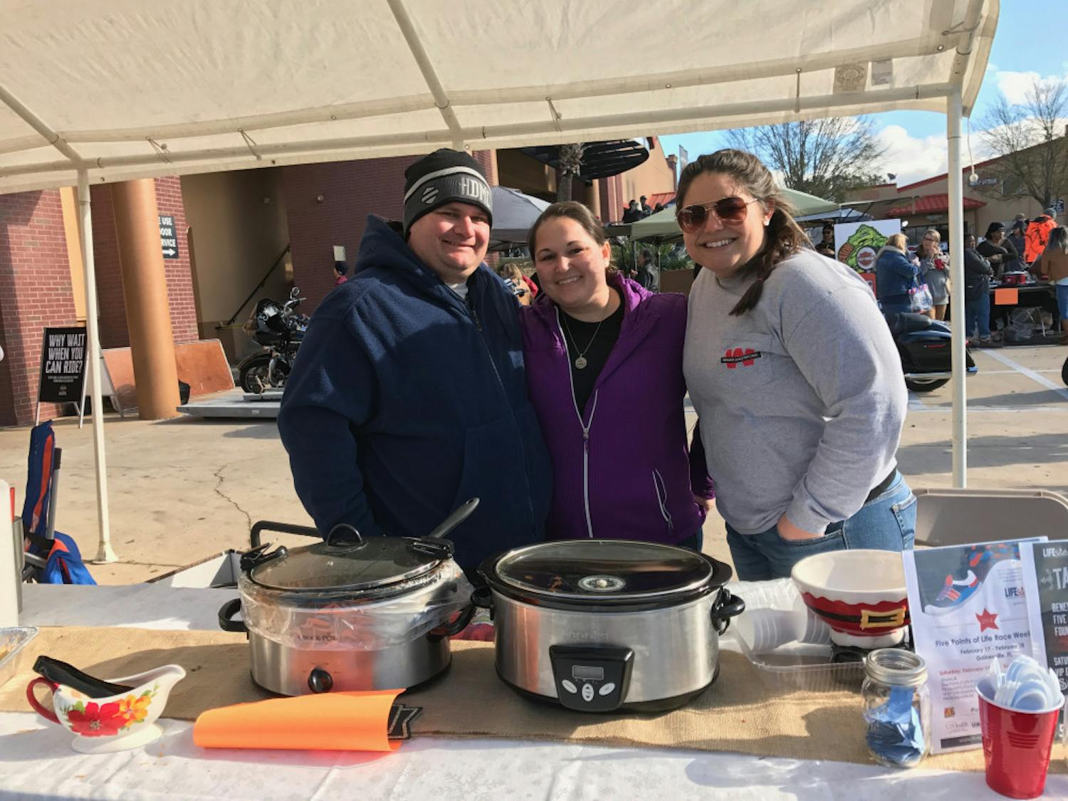 Ryan Long, Crystal Long and Alexa Craig pose behind their slow cooker full of chili. The team won third place in the 16th annual Chili Cook-Off to benefit the Basketball Cop Foundation on Saturday.