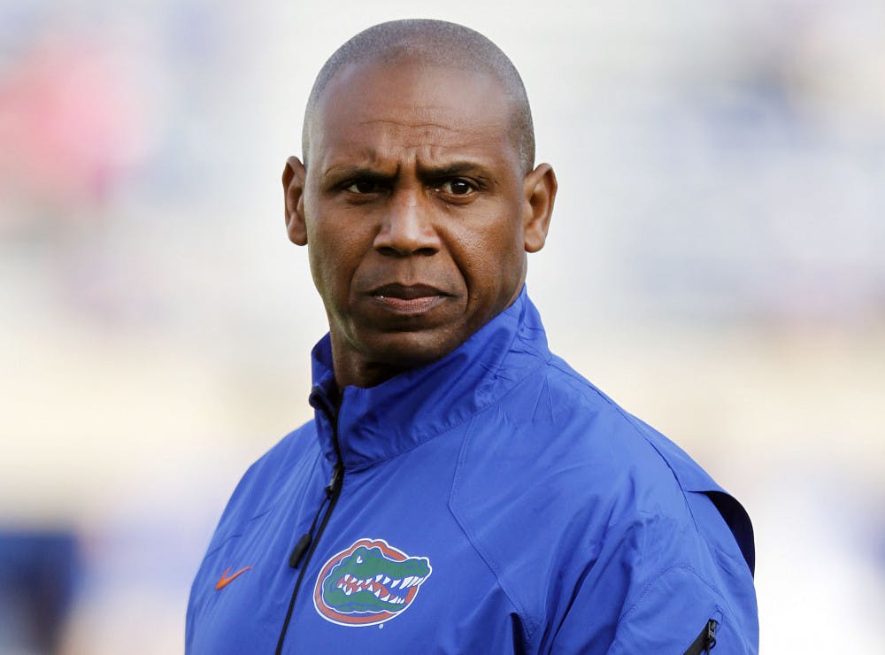 <p>Former Florida wide receivers coach Joker Phillips watches the Gators warm up before Florida’s 24-7 victorty against Kentucky on Sept. 28 in Lexington, Ky. Phillips resigned Wednesday after just one year as UF’s wide receivers coach.</p>