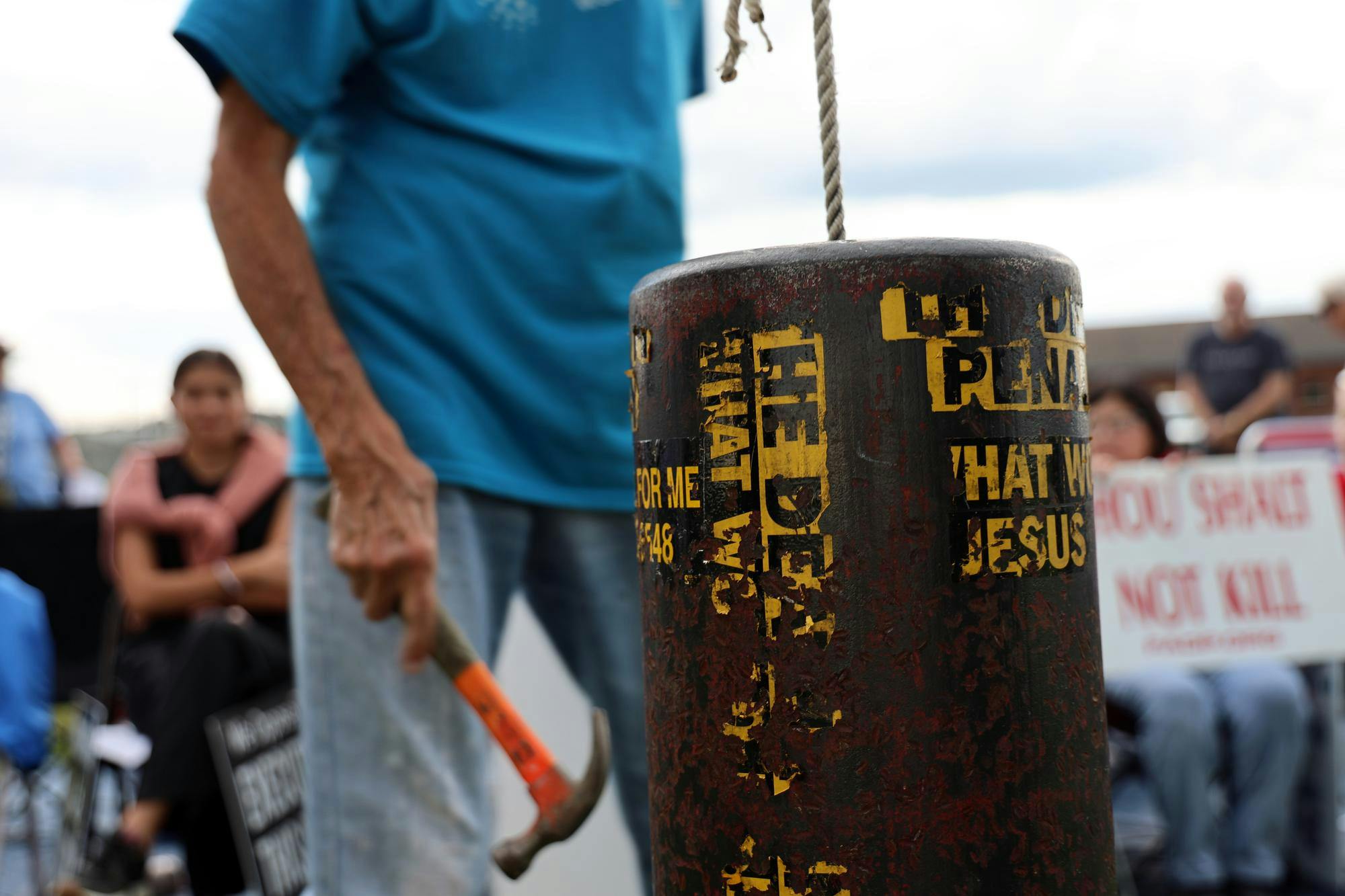 A protestor goes to ring the bell with a hammer while reciting the phrase "not in my name" in protest of the execution of Daniel Owen Conahan Jr., Thursday, Sept. 10, 2026, at the Florida State Prison in Raiford, Fla. 