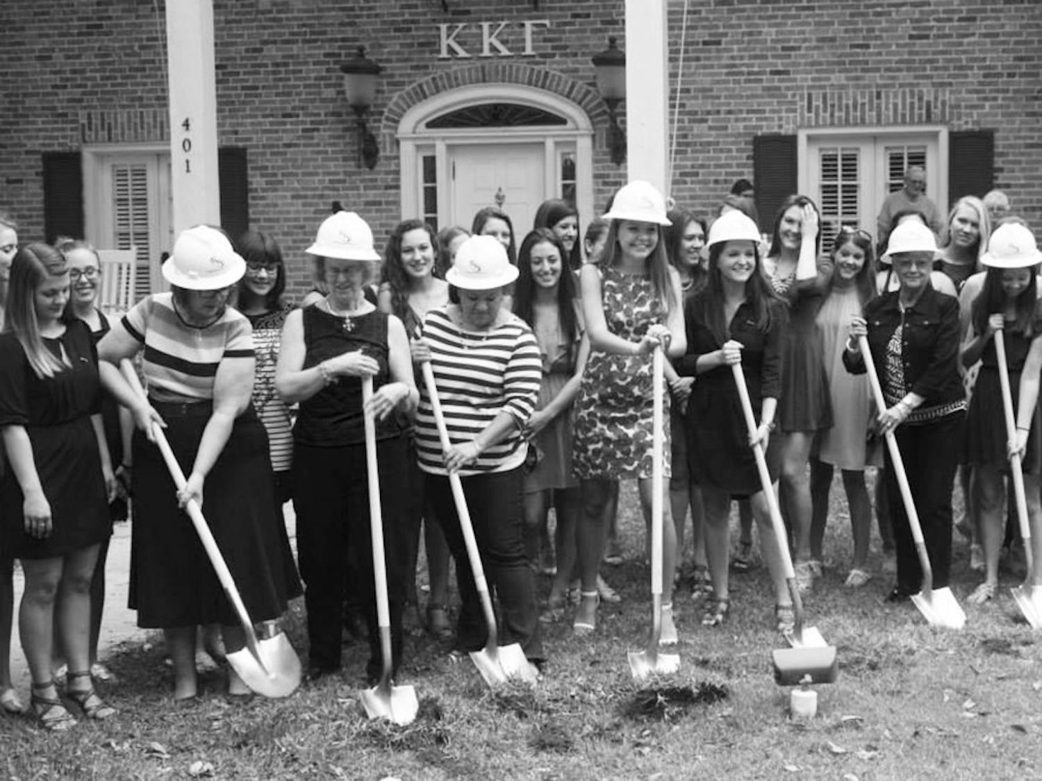 Members of Kappa Kappa Gamma break ground on their new house expansion Sunday afternoon. The renovations, which include an additional laundry room, are scheduled to be completed by Fall.