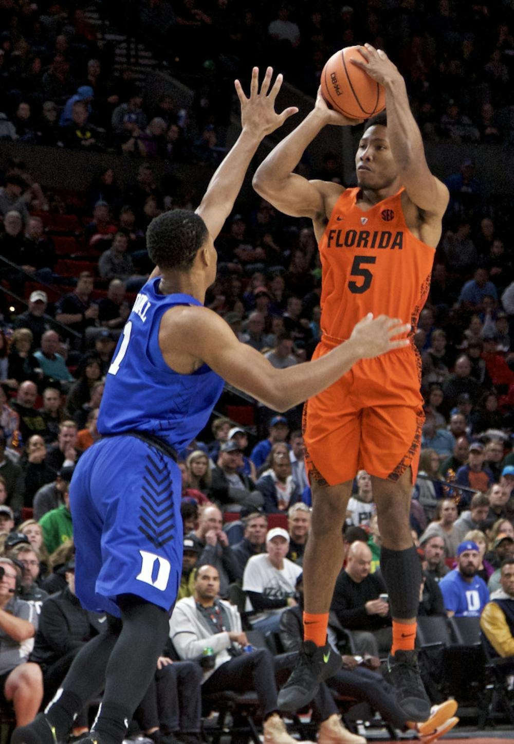 <p>Florida guard KeVaughn Allen, right, shoots over Duke guard Trevon Duval during the first half of an NCAA college basketball game in the Phil Knight Invitational tournament in Portland, Ore., Sunday, Nov. 26, 2017. (AP Photo/Craig Mitchelldyer)</p>