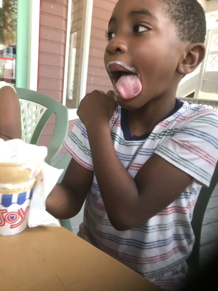 Photo of a child from Boys 2 Men summer camp eating ice cream