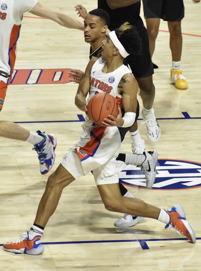 Sophomore Tre Mann drives into the chest of a Missouri defender Mar. 4.