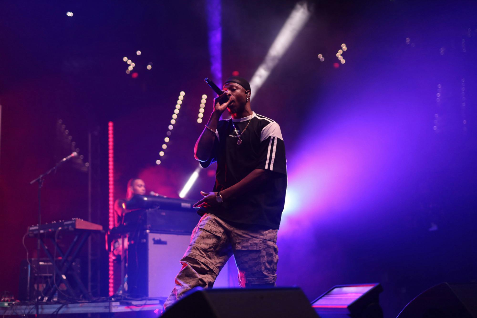 &nbsp;
As the lights dimmed in the Stephen C. O’Connell Center, the ground shook with students rising from their seats and introductory music reverberating through mega speakers attached to the ceiling. From the stage, a white fluorescent streak of light emerged through the smoke, crossing to point into the crowd. Then, from the wings, the long-awaited star of the night emerged.
“Oh man, University of Florida, what’s poppin’?” Joey Bada$$ yelled into his microphone, kicking off his set for the night as well as the start of the Fall semester.
Joey Bada$$ and Jean Deaux took to the stage to play a UF student-only concert at the O’Connell Center Wednesday night.