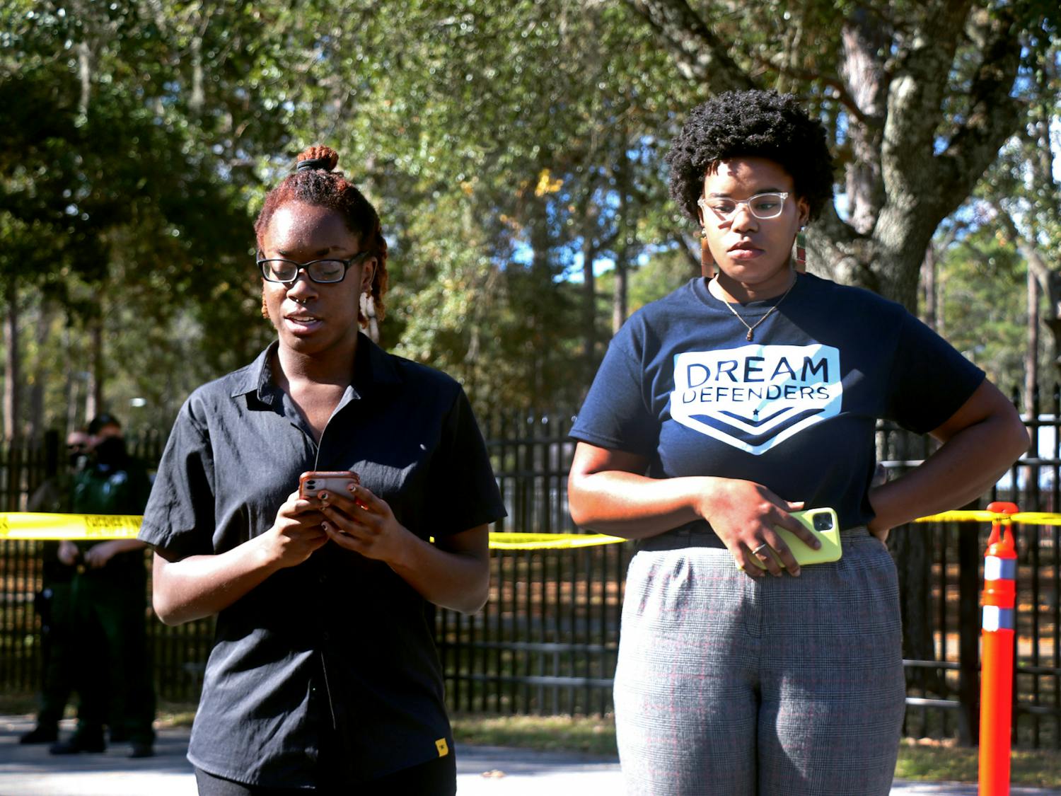 Jada Davis (left), transformative justice co-lead, and Kiara Laurent (right), digital communications coordinator, unveil Dream Defenders' demands at the Alachua County Jail. The organization gave Sheriff Clovis Watson 12 days to respond, which is how long they say Erica Thompson's cries for help were ignored.