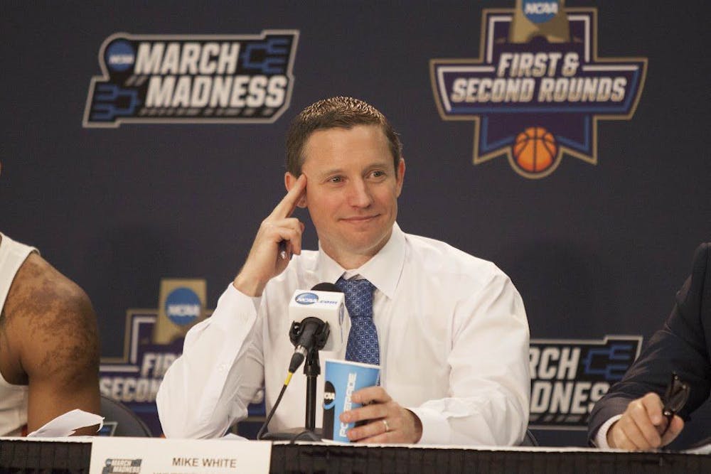<p>UF head coach Mike White smiles during a press conference following Florida's 65-39 win against Virginia in the NCAA Tournament on March 18, 2017, in Orlando.</p>
