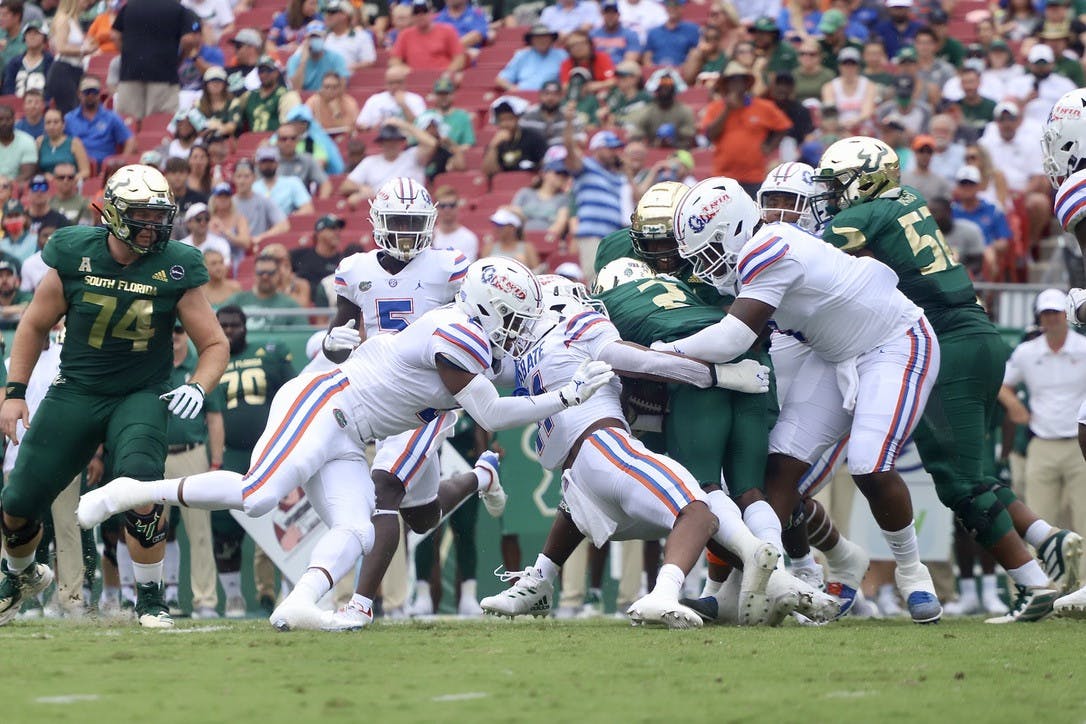 Florida's Mohamoud Diabate (11) and two other Gators tackle USF running back Darrian Felix during their 42-20 victory on Sept. 11.