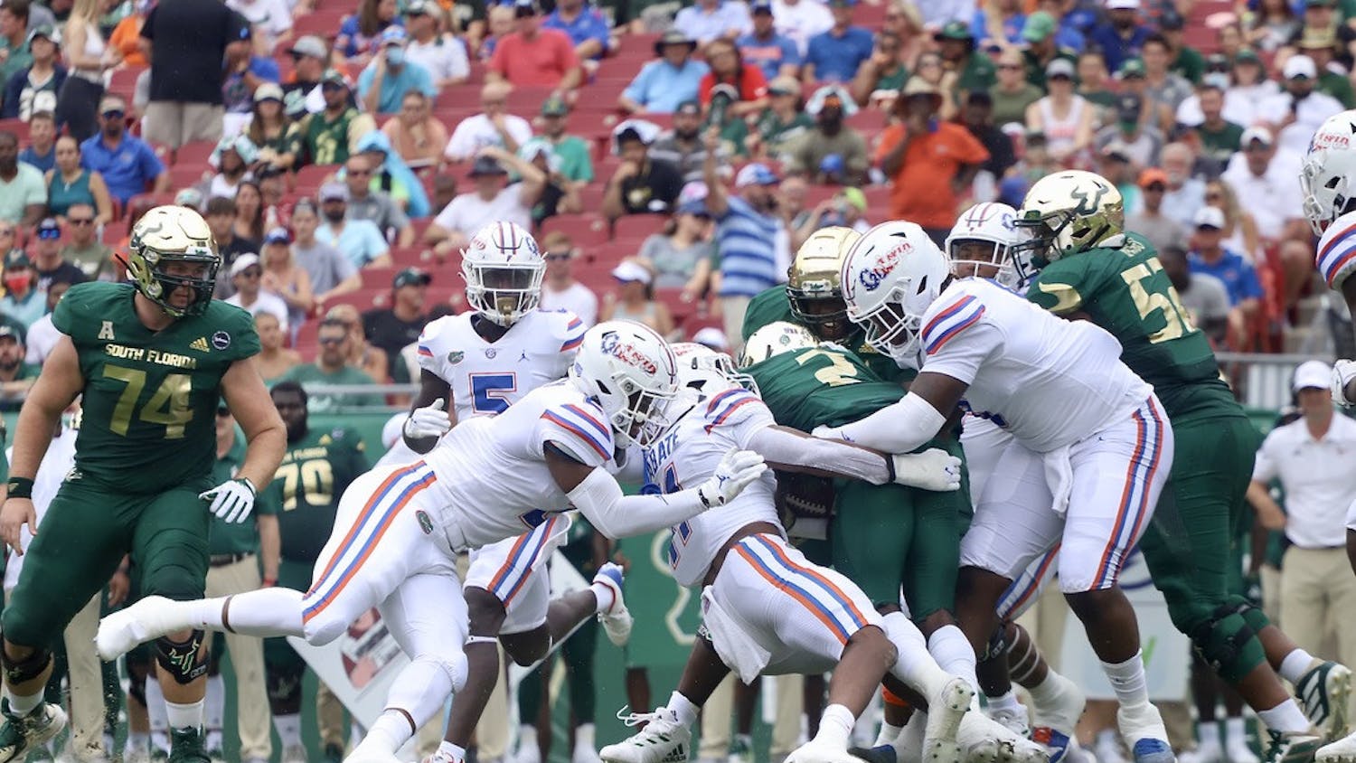 Florida's Mohamoud Diabate (11) and two other Gators tackle USF running back Darrian Felix during their 42-20 victory on Sept. 11.